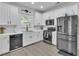 Bright kitchen features stainless appliances, gas range, and white cabinetry at 3610 Darcy Nw Ct, Kennesaw, GA 30144