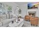 Bright living room features fireplace, modern lighting, large windows, and elegant furnishings at 3610 Darcy Nw Ct, Kennesaw, GA 30144