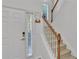 Staircase near the front door with carpeted steps and an elegant wooden banister at 3610 Darcy Nw Ct, Kennesaw, GA 30144