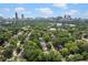 Scenic aerial view showcasing the property's location amidst lush greenery and the city skyline at 805 Ponce De Leon Ne Ter, Atlanta, GA 30306