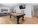 Basement featuring a pool table, a wet bar and a gray sofa; complete with a mounted TV at 805 Ponce De Leon Ne Ter, Atlanta, GA 30306
