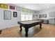 Entertaining basement featuring a pool table, a wet bar and a gray sofa for relaxing at 805 Ponce De Leon Ne Ter, Atlanta, GA 30306