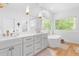 Bright bathroom with a soaking tub, double vanity, and a walk-in shower with glass door at 805 Ponce De Leon Ne Ter, Atlanta, GA 30306