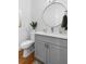 Bathroom featuring grey vanity, round mirror and modern fixtures at 805 Ponce De Leon Ne Ter, Atlanta, GA 30306