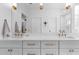 Stylish bathroom with white cabinets, dual sinks, brass hardware, and a large mirror above the quartz countertop at 805 Ponce De Leon Ne Ter, Atlanta, GA 30306