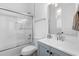 Clean bathroom featuring a glass door shower, white tiling, and light blue vanity at 805 Ponce De Leon Ne Ter, Atlanta, GA 30306