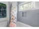 Bright bathroom with gray subway tile, shower with butterfly curtain, and niche shelving at 805 Ponce De Leon Ne Ter, Atlanta, GA 30306