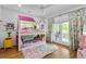 Fun bedroom with colorful bunk beds, hardwood floors, and natural light from French doors at 805 Ponce De Leon Ne Ter, Atlanta, GA 30306