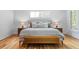 Well-lit bedroom with a plush bed, wooden floors, and a stylish bench at 805 Ponce De Leon Ne Ter, Atlanta, GA 30306