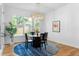 Bright dining area with round table, modern chandelier and picture window at 805 Ponce De Leon Ne Ter, Atlanta, GA 30306