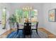 Bright dining area with round table, modern chandelier and view of backyard at 805 Ponce De Leon Ne Ter, Atlanta, GA 30306