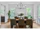 Elegant dining room with modern chandelier, hardwood floors, and large windows for natural light at 805 Ponce De Leon Ne Ter, Atlanta, GA 30306