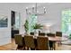 Bright dining room featuring a stylish chandelier, large windows, and sleek hardwood floors at 805 Ponce De Leon Ne Ter, Atlanta, GA 30306