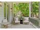 Cozy front porch with comfortable seating, exterior lighting, and views of the surrounding greenery at 805 Ponce De Leon Ne Ter, Atlanta, GA 30306