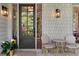 Welcoming porch featuring an exterior light, a door with glass panes, and a cozy outdoor seating arrangement at 805 Ponce De Leon Ne Ter, Atlanta, GA 30306
