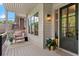 Inviting front porch with outdoor seating, a potted plant, and stylish exterior lighting fixtures at 805 Ponce De Leon Ne Ter, Atlanta, GA 30306