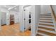 Bright hallway featuring light hardwood floors, white walls, and staircase to the upper level at 805 Ponce De Leon Ne Ter, Atlanta, GA 30306
