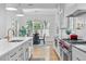 Open kitchen with stainless steel appliances, kitchen island, and adjacent dining area at 805 Ponce De Leon Ne Ter, Atlanta, GA 30306
