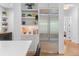 Kitchen with stainless steel refrigerator, floating shelves, and view into dining area at 805 Ponce De Leon Ne Ter, Atlanta, GA 30306