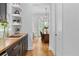 Bright kitchen with wood floors, floating shelves and view into dining area at 805 Ponce De Leon Ne Ter, Atlanta, GA 30306
