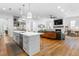Open kitchen and living space featuring a central island, modern appliances, and hardwood floors at 805 Ponce De Leon Ne Ter, Atlanta, GA 30306