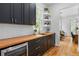 Kitchen with dark cabinets, a butcher block countertop, stainless steel appliances, and open shelving at 805 Ponce De Leon Ne Ter, Atlanta, GA 30306
