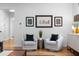 Cozy living room features two armchairs, wood floors, and Atlanta neighborhood artwork at 805 Ponce De Leon Ne Ter, Atlanta, GA 30306