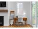 Modern office with wooden desk, fireplace, and sliding glass door to backyard at 805 Ponce De Leon Ne Ter, Atlanta, GA 30306