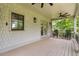 Covered porch with rocking chairs, ceiling fans and white shingle siding at 805 Ponce De Leon Ne Ter, Atlanta, GA 30306