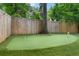 Private backyard putting green with well-maintained turf, ideal for golf enthusiasts at 805 Ponce De Leon Ne Ter, Atlanta, GA 30306