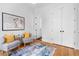 Light filled room showcasing hardwood floors, two chairs with yellow pillows, and bright white trim at 805 Ponce De Leon Ne Ter, Atlanta, GA 30306