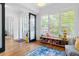 Open room featuring hardwood floors, large windows, playful decor, and a view of the outdoors at 805 Ponce De Leon Ne Ter, Atlanta, GA 30306
