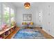 Bright room featuring hardwood floors, area rug, two chairs with yellow pillows and a window overlooking outdoor foliage at 805 Ponce De Leon Ne Ter, Atlanta, GA 30306