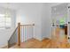 Bright staircase featuring wood floors and black iron railings leading to the upper level at 805 Ponce De Leon Ne Ter, Atlanta, GA 30306