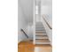 Staircase with wooden handrail and hardwood floors leading to the upper level at 805 Ponce De Leon Ne Ter, Atlanta, GA 30306