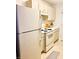 Kitchen featuring white appliances, including a refrigerator and range, alongside white cabinets at 19302 Waldrop Cv, Decatur, GA 30034