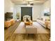 Staged living room with neutral decor, including wood floors, furniture, rug, and a ceiling fan at 19302 Waldrop Cv, Decatur, GA 30034