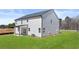 A view of the home's backyard, featuring a grassy lawn and the side of the house at 1950 Van Allen Ct, Dacula, GA 30019