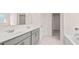 Elegant bathroom featuring double sinks, tub, and a separate entry to a walk-in closet at 1950 Van Allen Ct, Dacula, GA 30019