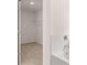 Bathroom showcasing a tiled tub with chrome fixtures and an adjacent walk-in closet at 1950 Van Allen Ct, Dacula, GA 30019