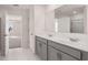 Bright bathroom featuring a double sink vanity with gray cabinets and a large mirror at 1950 Van Allen Ct, Dacula, GA 30019