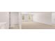 Spacious bonus room with plush carpeting and large windows that bring natural light into the home at 1950 Van Allen Ct, Dacula, GA 30019