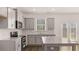 Well-appointed kitchen with gray cabinets, granite countertops, stainless steel appliances, and a center island at 1950 Van Allen Ct, Dacula, GA 30019