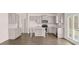 Open-concept kitchen with stainless steel appliances, island, and backyard access at 1950 Van Allen Ct, Dacula, GA 30019