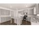 Contemporary kitchen boasting gray cabinetry, stainless steel appliances, and an island with granite countertops at 1950 Van Allen Ct, Dacula, GA 30019