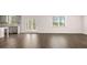 Open-concept living space with modern kitchen, stainless appliances, and hardwood flooring throughout at 1950 Van Allen Ct, Dacula, GA 30019