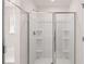 Modern bathroom featuring a glass-enclosed shower with built-in shelves and chrome fixtures at 1950 Van Allen Ct, Dacula, GA 30019