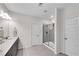 Modern bathroom with double sinks, white marble countertops, and tiled walk-in shower at 218 Jordan Dr, Woodstock, GA 30188