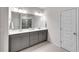 Bathroom with double sinks, gray vanity, marble countertops, and large mirror at 218 Jordan Dr, Woodstock, GA 30188