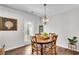 Cozy dining room with a wooden table, stylish chairs, and a modern light fixture at 218 Jordan Dr, Woodstock, GA 30188
